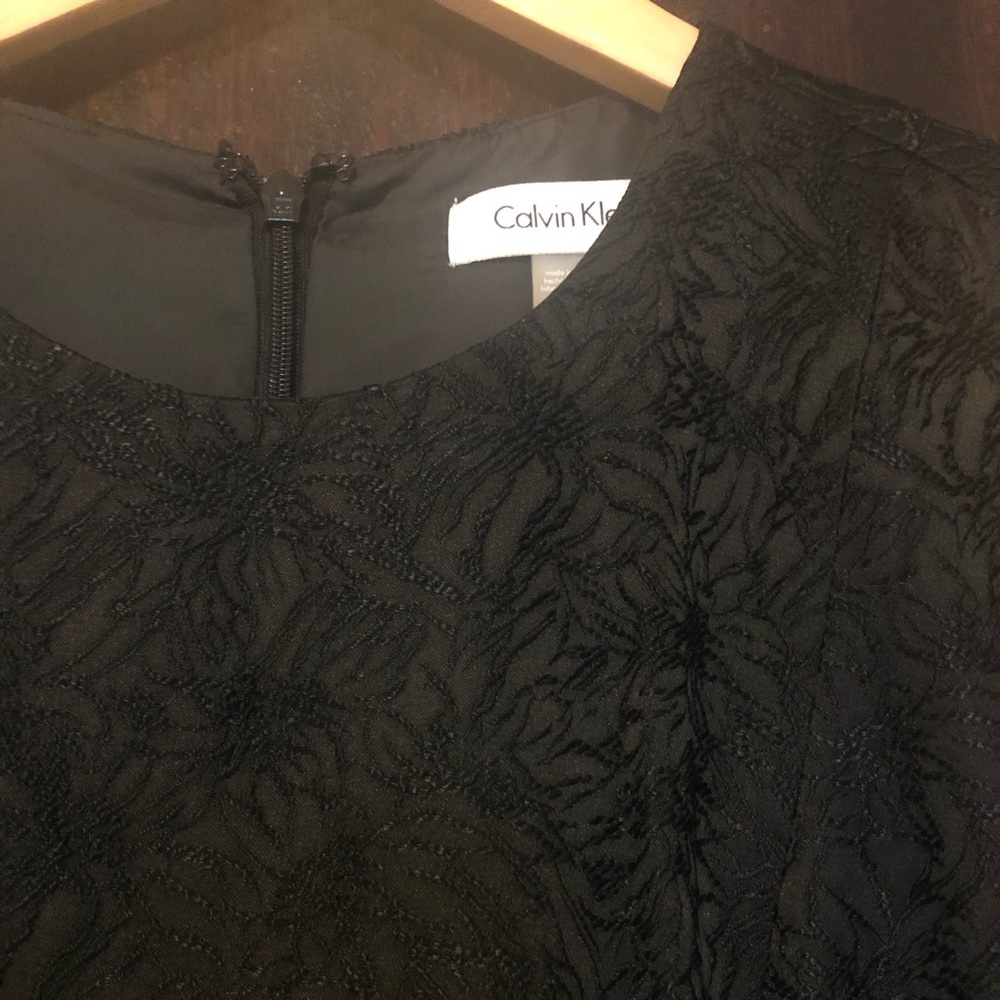 Calvin Klein. Black brocade-embroidered dress.